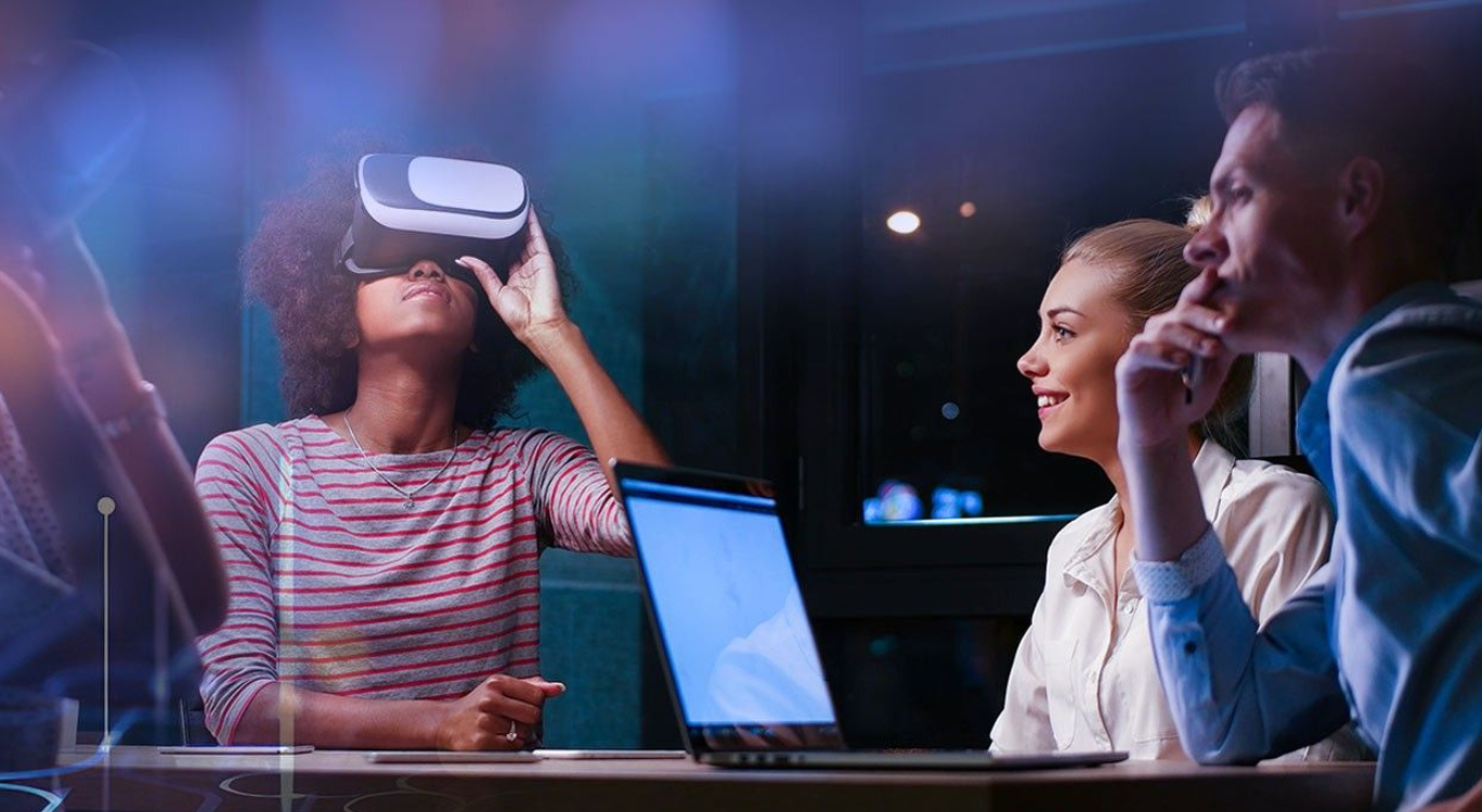 Image of young people around a table and looking into a VR viewer.