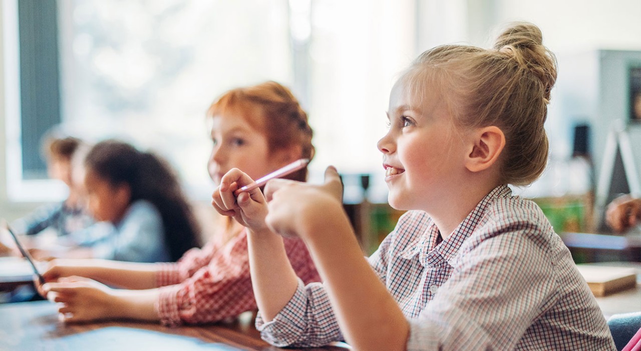 Children sitting in school and smiling