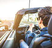 Man driving a convertible car