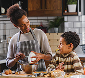 Mother and son cooking in kitchen