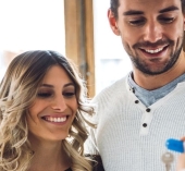 a couple smiling as they get their keys