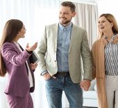 A couple talking with realtor