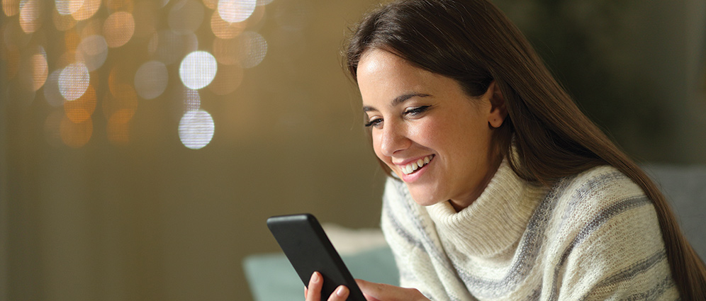 Woman smiling looking at phone