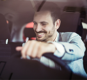 Man in car staring at radio or navigation system