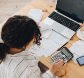 Person using calculator to track finances