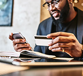 A man smiling looking at his phone.