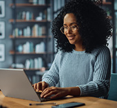 Woman sitting at laptop, updating her device and browsers