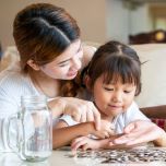 mom and daughter sitting down and counting coins