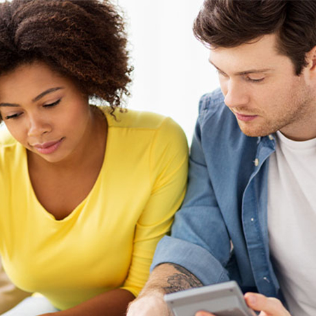 couple looking at bills and calculator