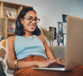 Woman sitting at laptop smiling