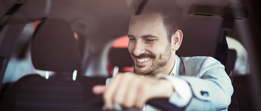 Man smiling inside of car