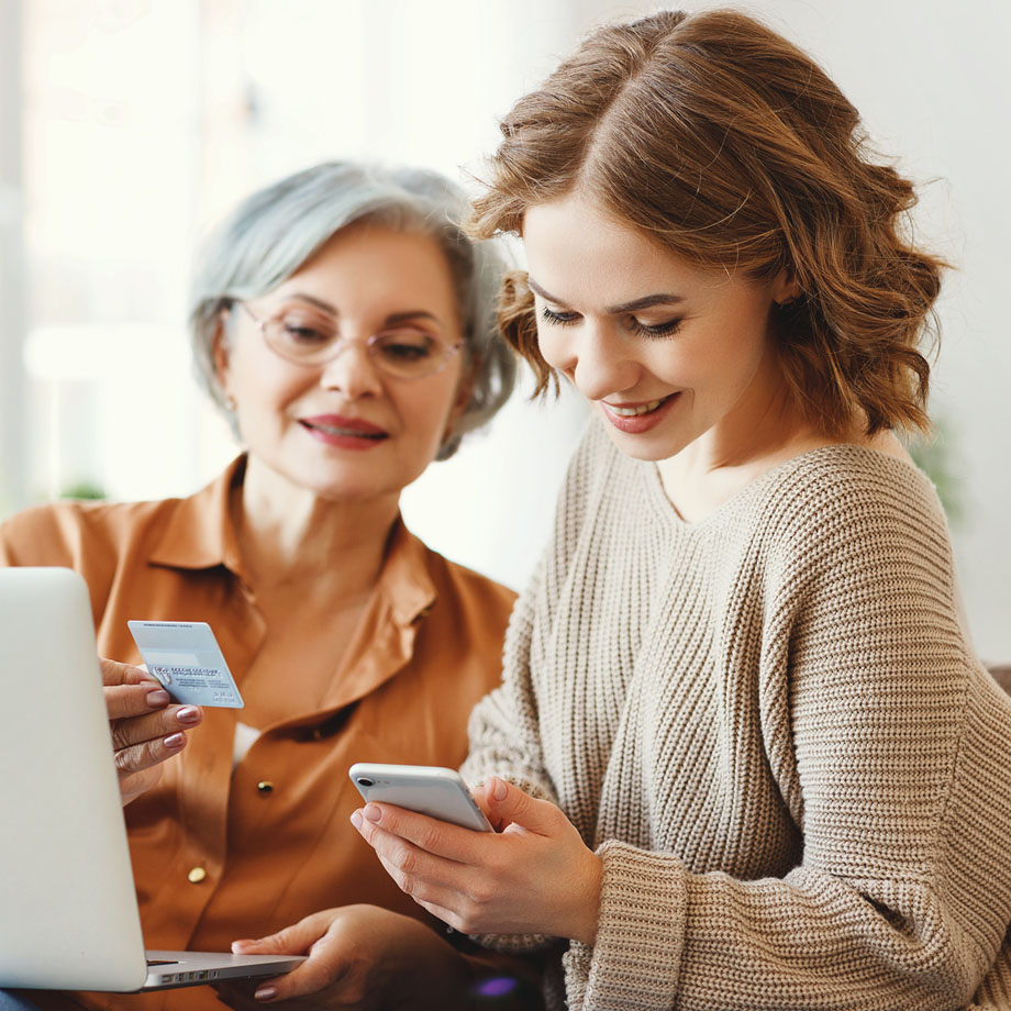 Mother and daughter smiling at a phone