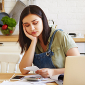 A woman looking at her bills