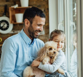 Father giving his daughter a dog