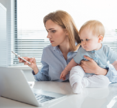 Woman with with her child looking at a laptop
