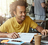 Young man sitting in cafe studying