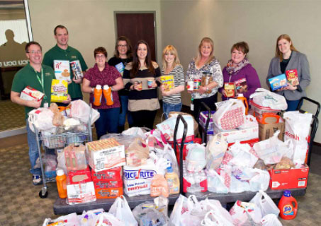 A group of DCU employees donating goods to a community group.