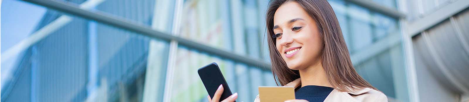 woman on phone with credit card