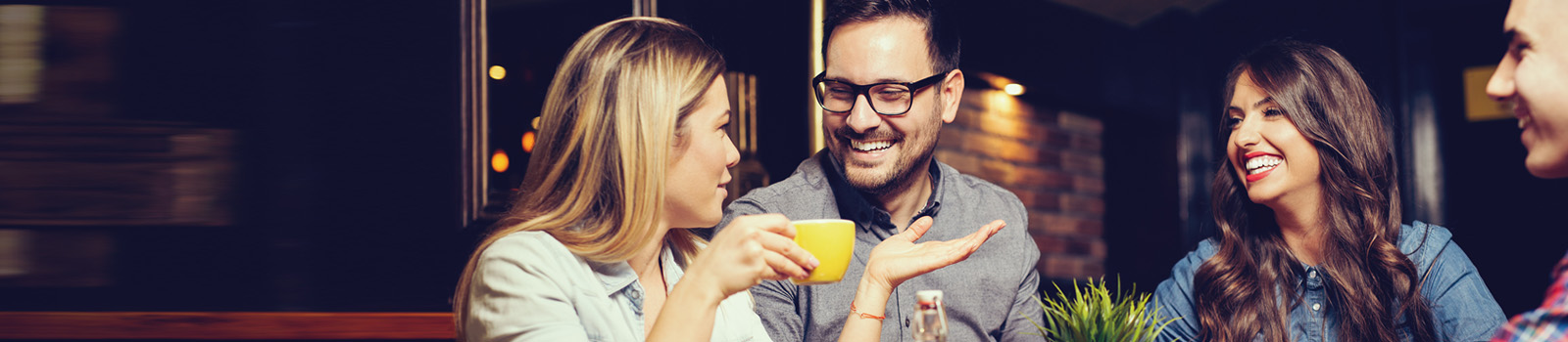 two women and two men smiling and talking