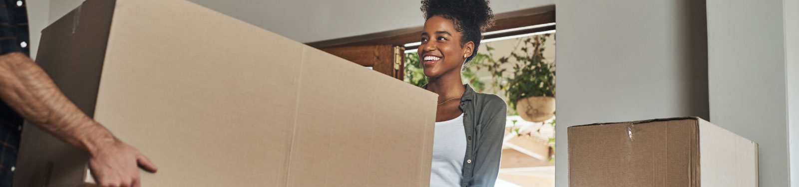 Woman holding a cardboard box. 