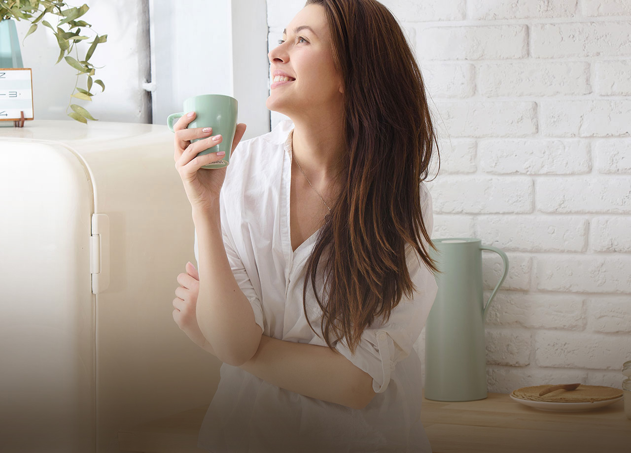 Woman smiling holding a cup