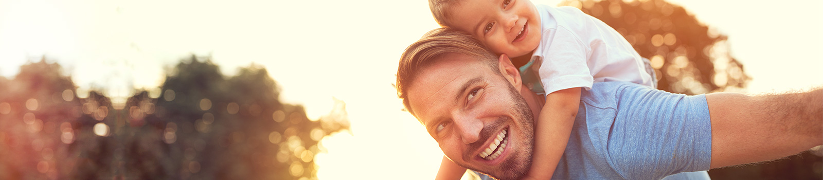 Father with toddler son on shoulders.