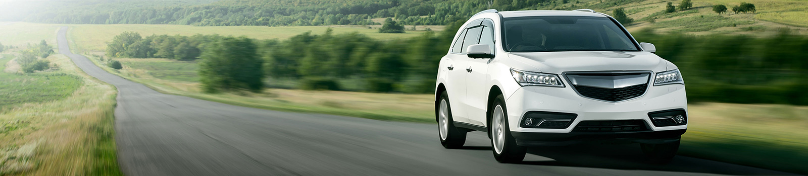 a brand new white car zooming past lush green country countryside