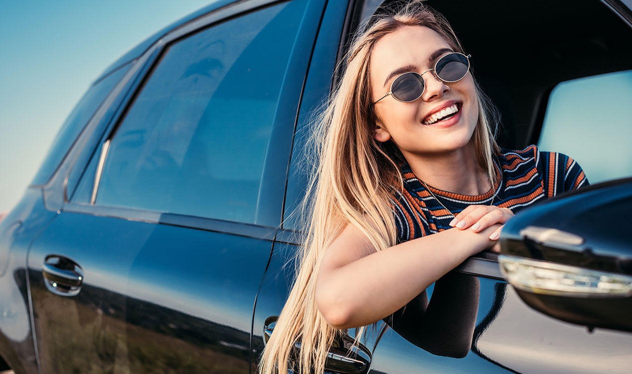 happy female passenger in car