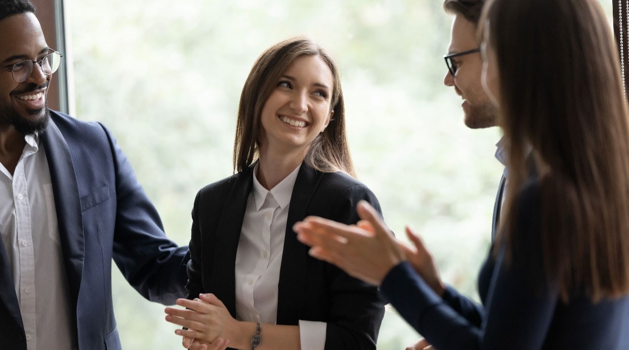 Men and Women smiling and clapping hands