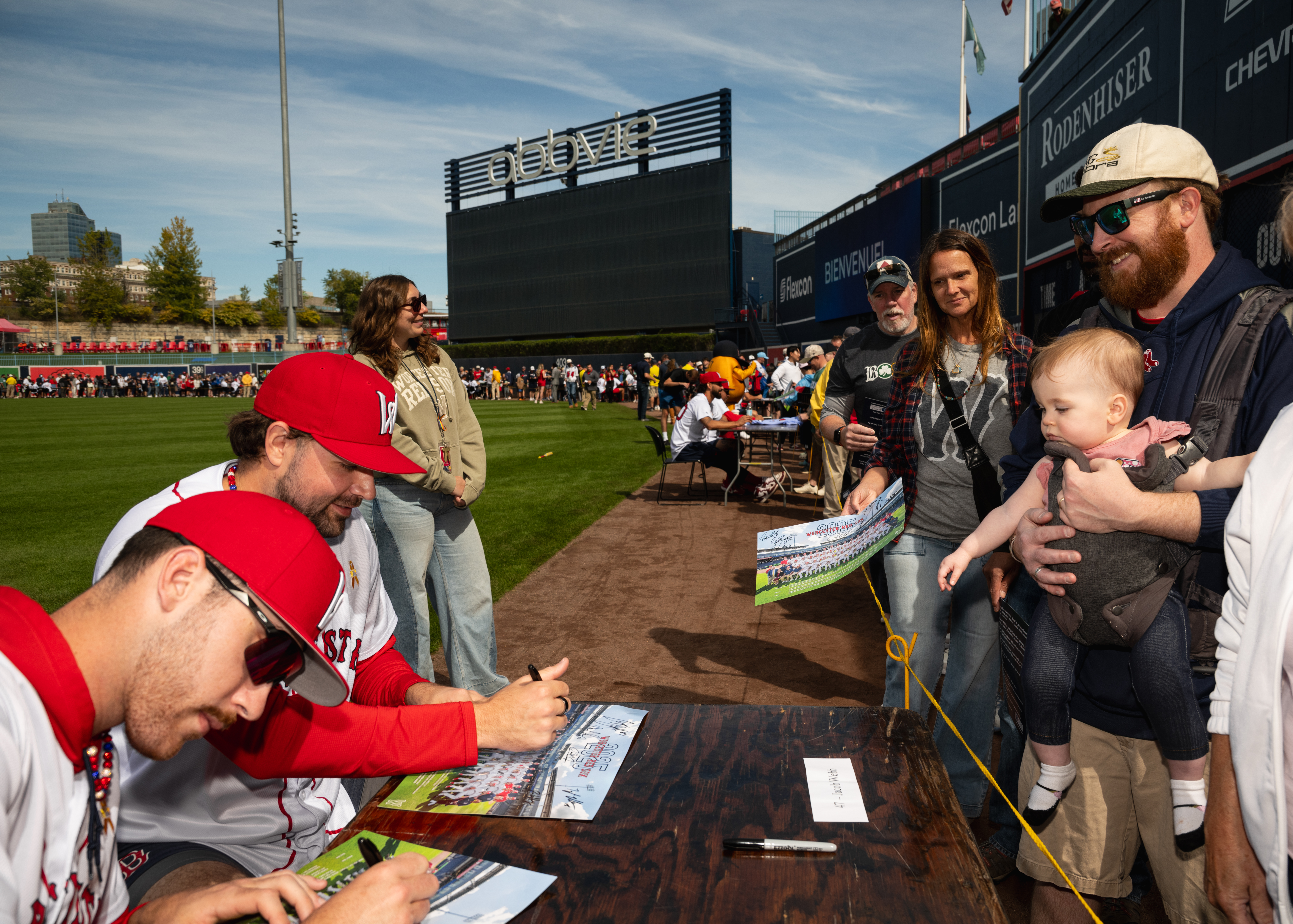 Worcester Red Sox players signing autographs for fans after a 2025 season game.