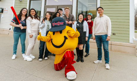 Smiley Ball, the iconic yellow mascot of the Worcester Red Sox, happily poses in front of a Worcester DCU branch entrance during March Member Appreciation Days.