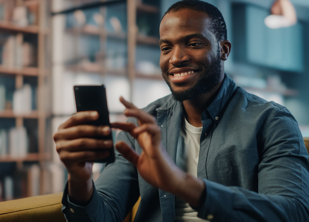 Man smiling at his phone
