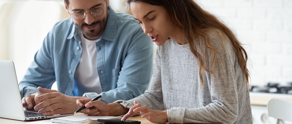 Couple sitting together going over budget notes. 