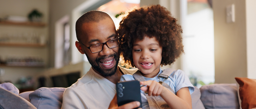 Man using mobile device with child