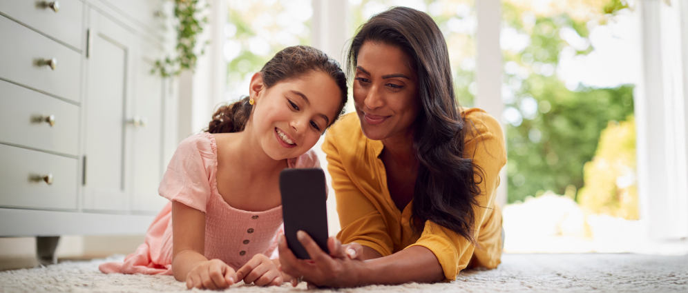 Parent and child looking at phone together