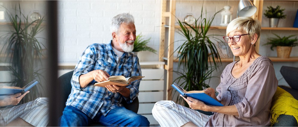 A couple laughing with books in hand