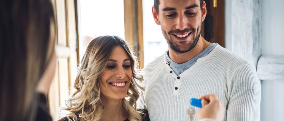 Happy couple receiving house keys