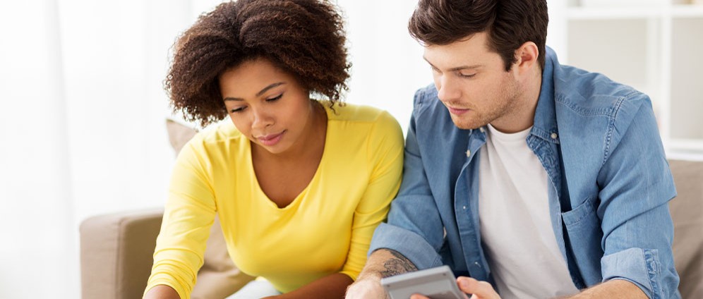 Couple looking at bills and calculator