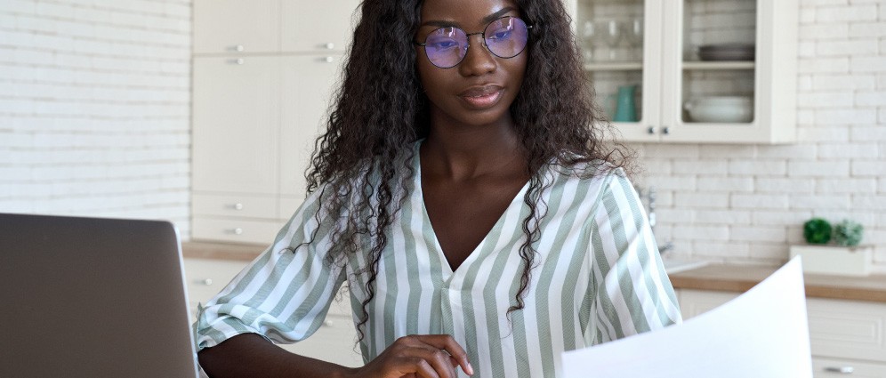 A woman looking over her student loan paperwork.