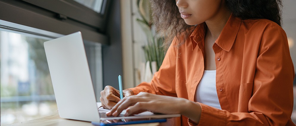 Woman taking notes at her computer