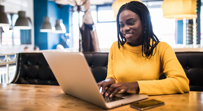 Woman using her laptop while sitting at a desk