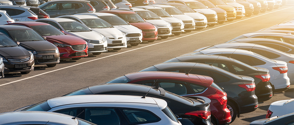 rows of cars in a parking lot spread diagonally 
