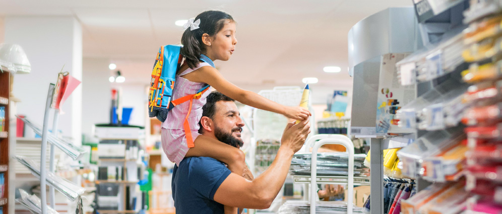 Man with a child shopping for school supplies