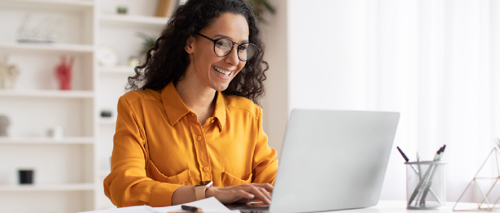 Woman smiling and looking at laptop