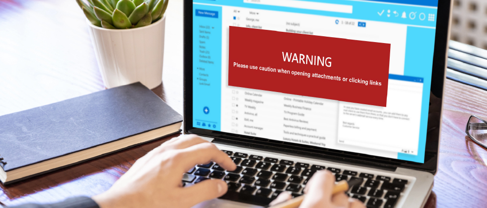 Close up of a laptop screen displaying a warning message