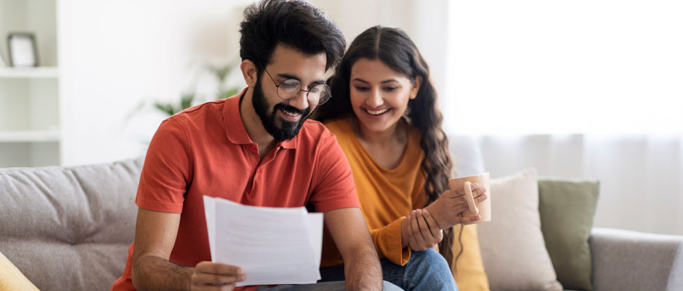 A couple sitting on the couch and smiling