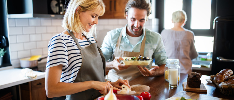 A smiling couple cooking together