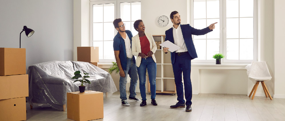A couple touring a house with a realtor