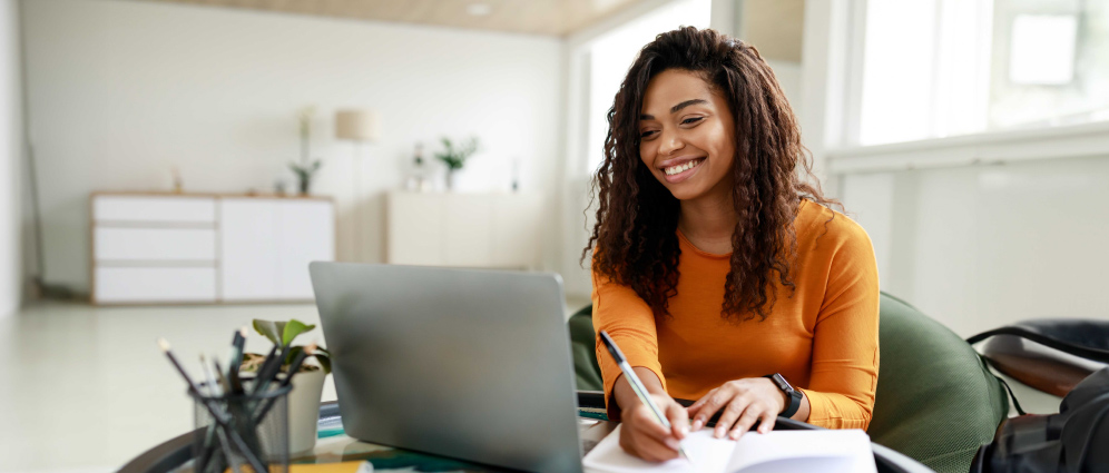 A woman looking at her computer and smiling